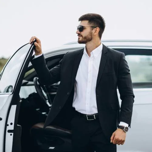 Happy client getting out of a luxury limousine