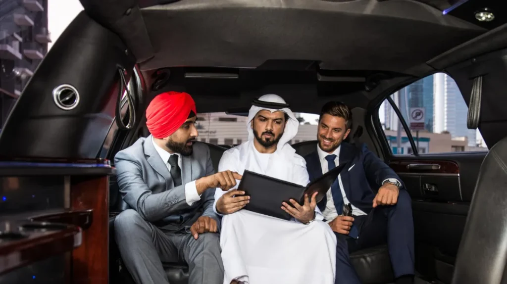 Three business professionals discussing reports inside a limousine during a business trip